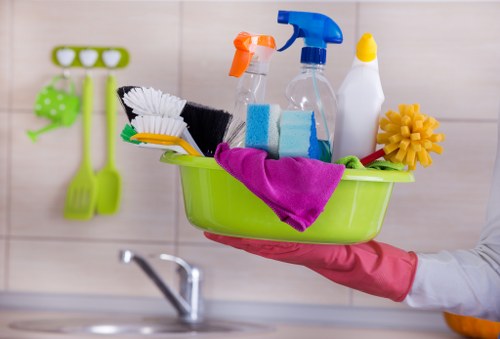 Technician using professional equipment for upholstery cleaning on a chair