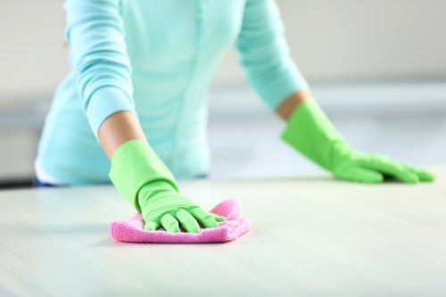 Housekeeper making bed with crisp sheets in an Airbnb bedroom